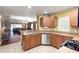 Kitchen with stainless steel appliances and wood cabinets at 17409 New Cross Cir, Lithia, FL 33547