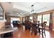 Spacious living room with hardwood floors, leather furniture, and a large TV at 17409 New Cross Cir, Lithia, FL 33547