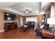 Spacious living area with hardwood floors and a large TV at 17409 New Cross Cir, Lithia, FL 33547