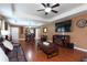 Open concept living room with hardwood floors and large TV at 17409 New Cross Cir, Lithia, FL 33547
