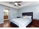 Main bedroom with light blue walls, hardwood floors, and ceiling fan at 17409 New Cross Cir, Lithia, FL 33547