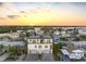 Stunning sunset view of a modern waterfront home at 18077 3Rd St, Redington Shores, FL 33708