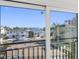 View from balcony showcasing waterfront homes and palm trees at 18077 3Rd St, Redington Shores, FL 33708