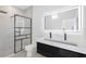 Modern bathroom with a frameless glass shower, floating vanity, and LED mirror at 18077 3Rd St, Redington Shores, FL 33708