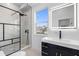 Contemporary bathroom with a walk-in shower, floating vanity, and window at 18077 3Rd St, Redington Shores, FL 33708