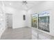 Bedroom with hardwood floors, sliding glass doors to a private balcony, and access to hallway at 18077 3Rd St, Redington Shores, FL 33708