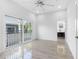 Light-filled bedroom with hardwood floors, sliding doors to balcony, and ensuite bathroom at 18077 3Rd St, Redington Shores, FL 33708