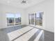 Bedroom with sliding doors to a balcony and hardwood floors at 18077 3Rd St, Redington Shores, FL 33708
