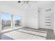 Spacious bedroom with hardwood floors, sliding glass doors to balcony, and ceiling fan at 18077 3Rd St, Redington Shores, FL 33708