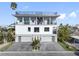 Modern coastal home with a rooftop deck and three-car garage at 18077 3Rd St, Redington Shores, FL 33708