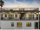 Multi-level home with balconies and spiral staircase at sunset at 18077 3Rd St, Redington Shores, FL 33708