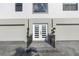 Contemporary home entrance with double doors and gray pavers at 18077 3Rd St, Redington Shores, FL 33708