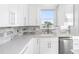 Modern kitchen with white cabinets and marble backsplash at 18077 3Rd St, Redington Shores, FL 33708