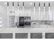 Modern kitchen with white cabinets and a large island at 18077 3Rd St, Redington Shores, FL 33708