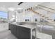 Modern kitchen with grey cabinetry and quartz countertops at 18077 3Rd St, Redington Shores, FL 33708