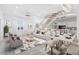 Modern living room with open floor plan, staircase, and dining area at 18077 3Rd St, Redington Shores, FL 33708