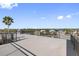 Spacious rooftop deck with water views and metal railings at 18077 3Rd St, Redington Shores, FL 33708