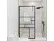 Modern shower with black frame and patterned tile at 18077 3Rd E St, Redington Shores, FL 33708