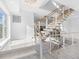 Modern staircase with metal railing and wood steps at 18077 3Rd St, Redington Shores, FL 33708