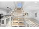 Modern staircase with wood steps and metal railing at 18077 3Rd St, Redington Shores, FL 33708