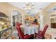 Bright dining room featuring a chandelier and floral-patterned rug at 1819 Ravenridge St, Wesley Chapel, FL 33543