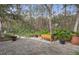 Brick paved patio with wooden planter box, offering a peaceful outdoor space at 19387 Hidden Oaks Dr, Brooksville, FL 34604