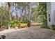 Landscaped brick patio with various plants and a wooden planter box at 19387 Hidden Oaks Dr, Brooksville, FL 34604