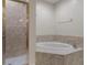 Bathroom with shower and corner bathtub at 19387 Hidden Oaks Dr, Brooksville, FL 34604