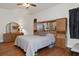 Primary bedroom with wood floors and built-in storage at 19387 Hidden Oaks Dr, Brooksville, FL 34604