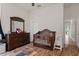 Bright bedroom with crib, dresser, and access to hallway at 19387 Hidden Oaks Dr, Brooksville, FL 34604