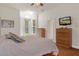 Primary bedroom with wood floors and backyard access at 19387 Hidden Oaks Dr, Brooksville, FL 34604