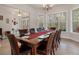 Spacious dining room with large table, hardwood floors, and lots of natural light at 19387 Hidden Oaks Dr, Brooksville, FL 34604