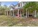 Two-story home with wrap-around porch and large yard at 19387 Hidden Oaks Dr, Brooksville, FL 34604