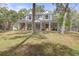 Two-story house with wraparound porch and large yard at 19387 Hidden Oaks Dr, Brooksville, FL 34604