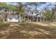 Two-story home with wrap-around porch and large yard at 19387 Hidden Oaks Dr, Brooksville, FL 34604