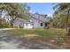 Gray house with attached garage and American flag at 19387 Hidden Oaks Dr, Brooksville, FL 34604