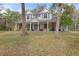 Two-story home with wrap-around porch and large yard at 19387 Hidden Oaks Dr, Brooksville, FL 34604