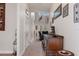 Long hallway with hardwood floors and antique furniture at 19387 Hidden Oaks Dr, Brooksville, FL 34604
