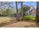Two-story house with a screened-in porch and lush landscaping at 19387 Hidden Oaks Dr, Brooksville, FL 34604