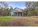 Two-story house with screened porch and large backyard at 19387 Hidden Oaks Dr, Brooksville, FL 34604