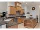 Kitchen boasts granite countertops, ample cabinetry, and stainless steel appliances at 19387 Hidden Oaks Dr, Brooksville, FL 34604