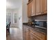 Built-in kitchen cabinets and granite countertops with microwave at 19387 Hidden Oaks Dr, Brooksville, FL 34604