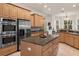 Bright kitchen with stainless steel appliances and large island at 19387 Hidden Oaks Dr, Brooksville, FL 34604