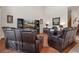 Relaxing living room with leather recliners and a large TV at 19387 Hidden Oaks Dr, Brooksville, FL 34604