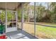 Screened porch overlooking a fenced backyard at 19387 Hidden Oaks Dr, Brooksville, FL 34604