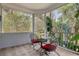 Relaxing screened porch overlooking wooded area at 19387 Hidden Oaks Dr, Brooksville, FL 34604