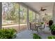 Relaxing screened porch overlooking the backyard, complete with seating and ceiling fans at 19387 Hidden Oaks Dr, Brooksville, FL 34604