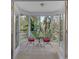 Screened porch with outdoor seating and nature views at 19387 Hidden Oaks Dr, Brooksville, FL 34604