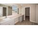 Double vanity bathroom with walk-in closet at 2049 Stillview Pass, Zephyrhills, FL 33541