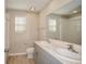 Modern bathroom with double vanity, light gray cabinets, and light flooring at 2049 Stillview Pass, Zephyrhills, FL 33541